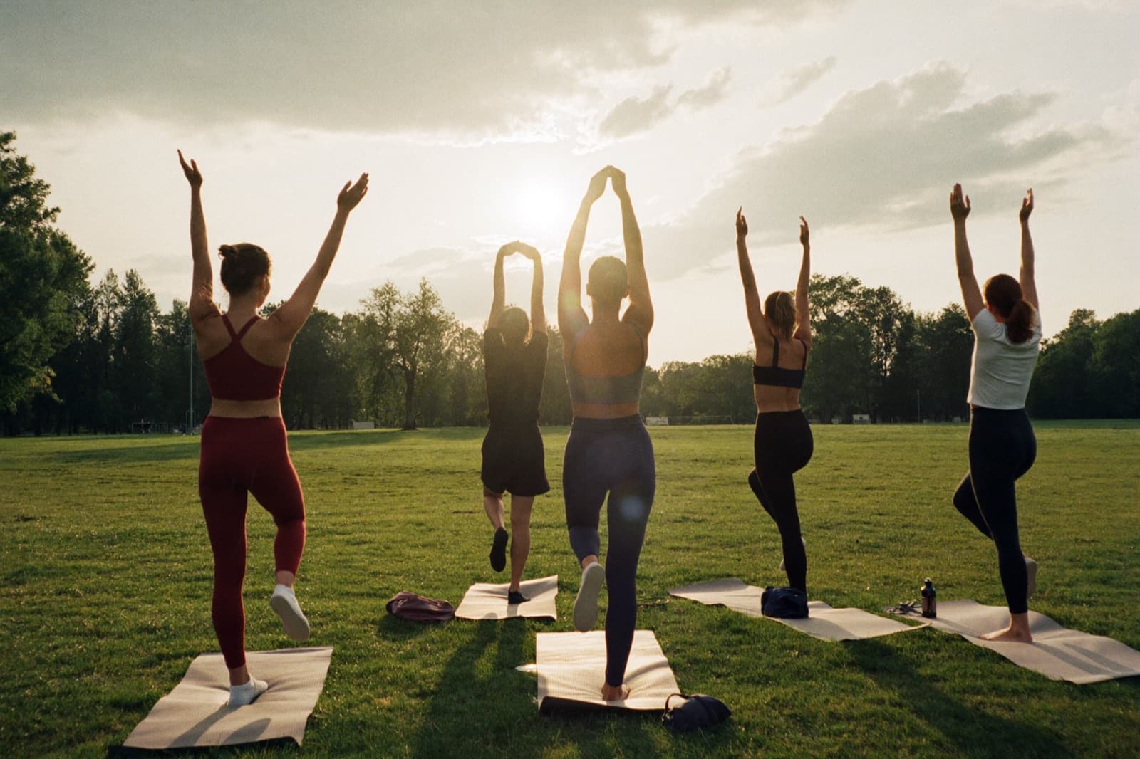 A small group training class outdoors at golden hour